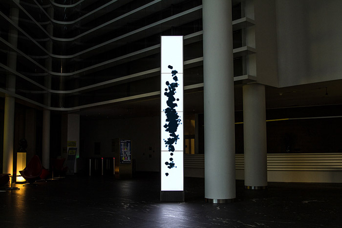 The installation Monolith's visual chapter cooling shows various colorful blobs of different shapes and sizes, in blue-ish grey.